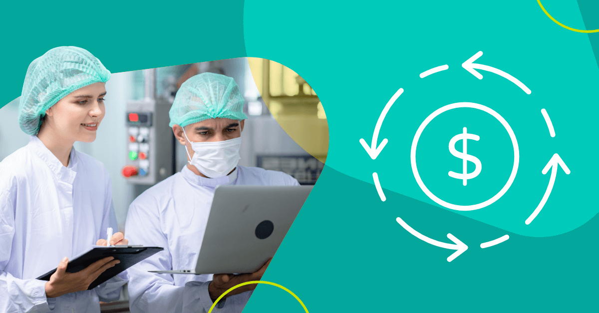 Two workers in food manufacturing plant looking at laptop